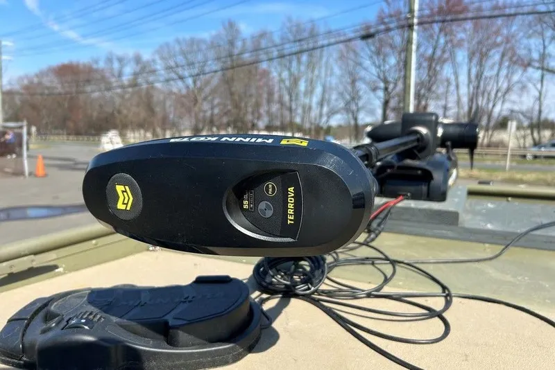 Slide: The Image of Minn Kota Terrova trolling motor on 2024 Lund UR1448MTD boat, outdoor setting. - 13