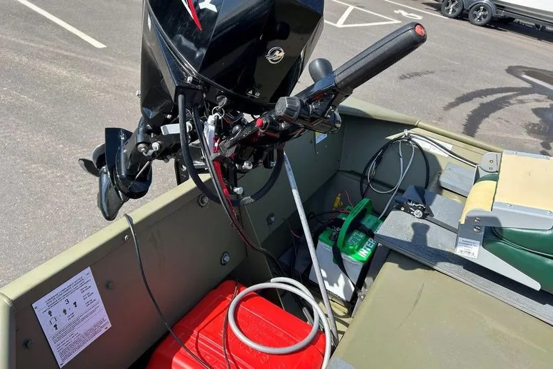 Slide: The Image of 2024 Lund UR1448MTD boat interior with motor, battery, and seating. - 3