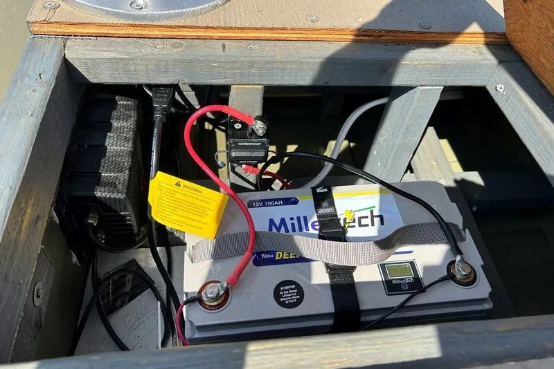 Slide: The Image of Battery setup in a 2024 Lund UR1448MTD boat, featuring a MillerTech deep cycle battery. - 9