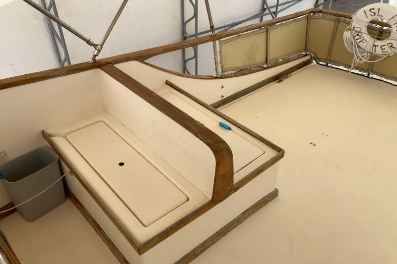 Slide: The Image of 1988 Albin 43 Trawler deck with seating and life preserver. - 12