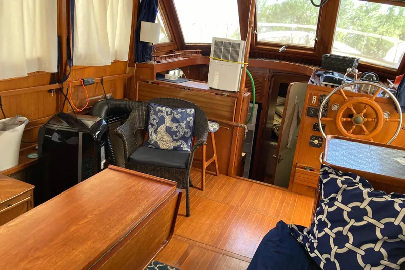 Slide: The Image of Interior of 1988 Albin 43 Trawler with wooden decor and nautical-themed cushions. - 17