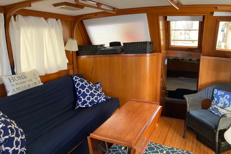 Slide: The Image of Interior of 1988 Albin 43 Trawler with cozy seating and nautical decor. - 19