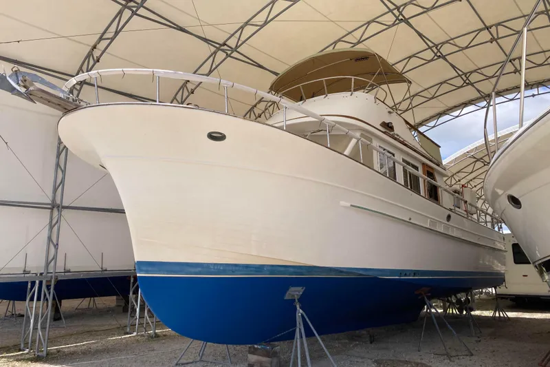 Slide: The Image of 1988 Albin 43 Trawler in covered storage, showcasing classic design and blue hull. - 2