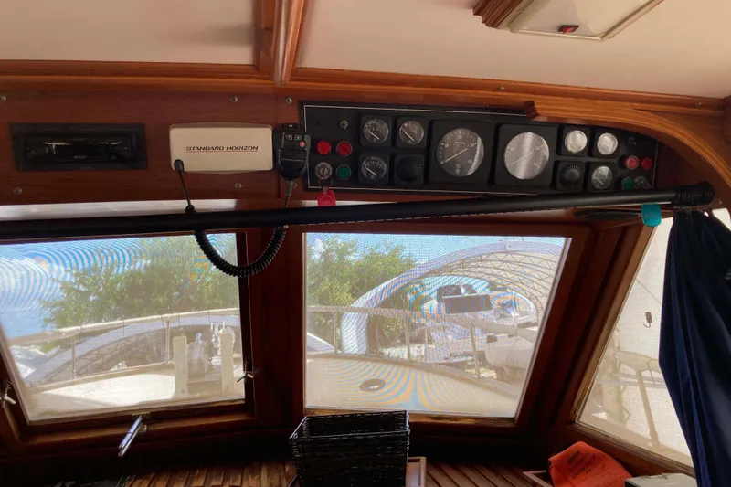 Slide: The Image of Interior view of 1988 Albin 43 Trawler dashboard with gauges and radio equipment. - 21