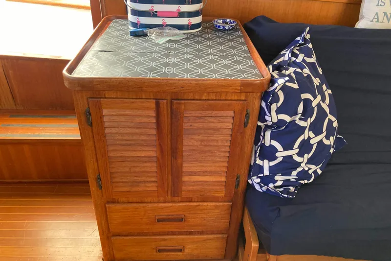 Slide: The Image of Wooden cabinet and nautical-themed decor inside a 1988 Albin 43 Trawler boat. - 22
