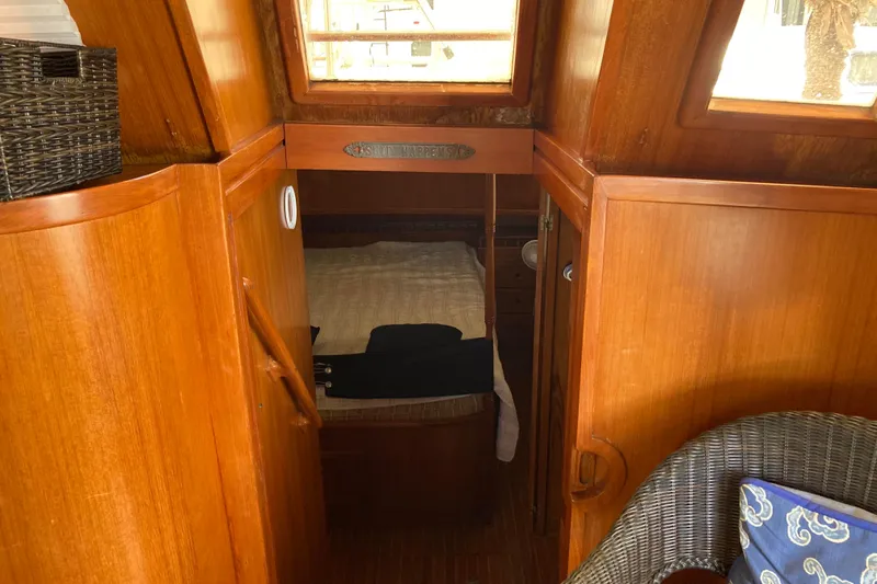 Slide: The Image of Cozy cabin interior of 1988 Albin 43 Trawler with wooden finish and wicker chair. - 25