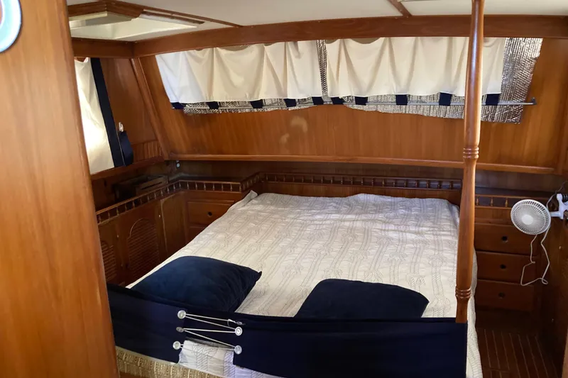 Slide: The Image of Interior cabin of 1988 Albin 43 Trawler with wood paneling and cozy bed. - 26