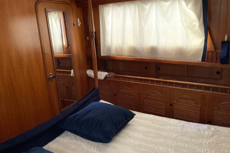 Slide: The Image of Cozy cabin interior of 1988 Albin 43 Trawler with wooden furnishings and blue accents. - 29