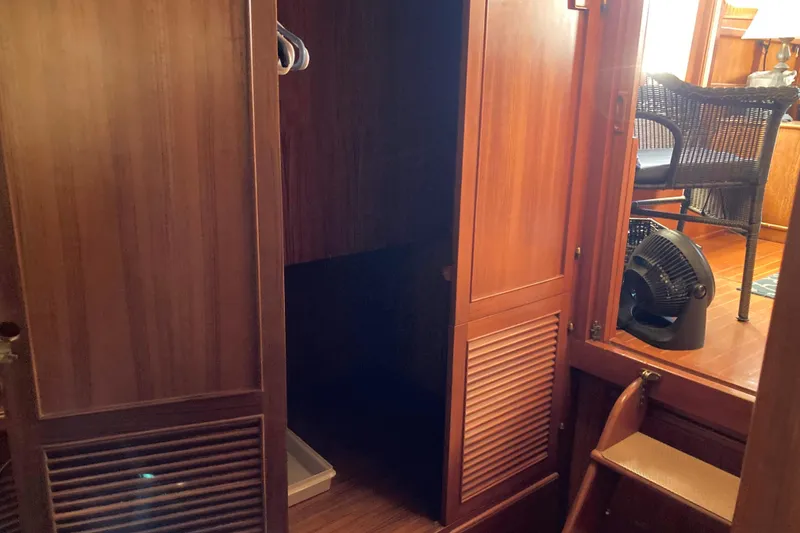 Slide: The Image of Interior of 1988 Albin 43 Trawler with wooden cabinetry and seating area. - 30