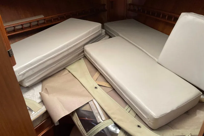 Slide: The Image of Cushions stacked inside 1988 Albin 43 Trawler cabin, showcasing interior storage space. - 33