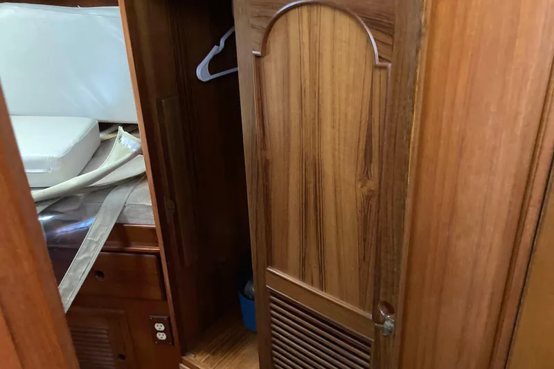 Slide: The Image of Interior of 1988 Albin 43 Trawler with wooden cabinetry and storage space. - 36