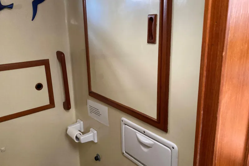 Slide: The Image of Interior of 1988 Albin 43 Trawler bathroom with wooden accents and fixtures. - 39