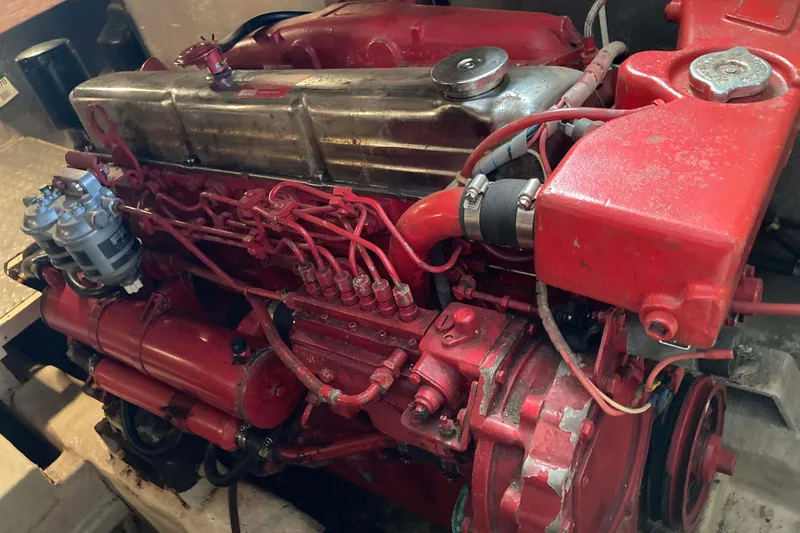 Slide: The Image of Red engine of a 1988 Albin 43 Trawler, showcasing intricate mechanical components. - 42