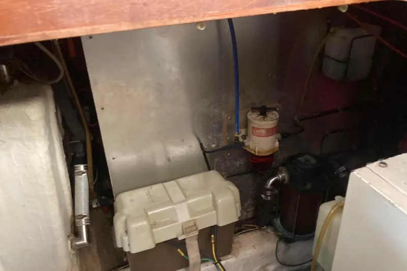 Slide: The Image of Engine room of 1988 Albin 43 Trawler, showcasing mechanical components and wiring. - 44