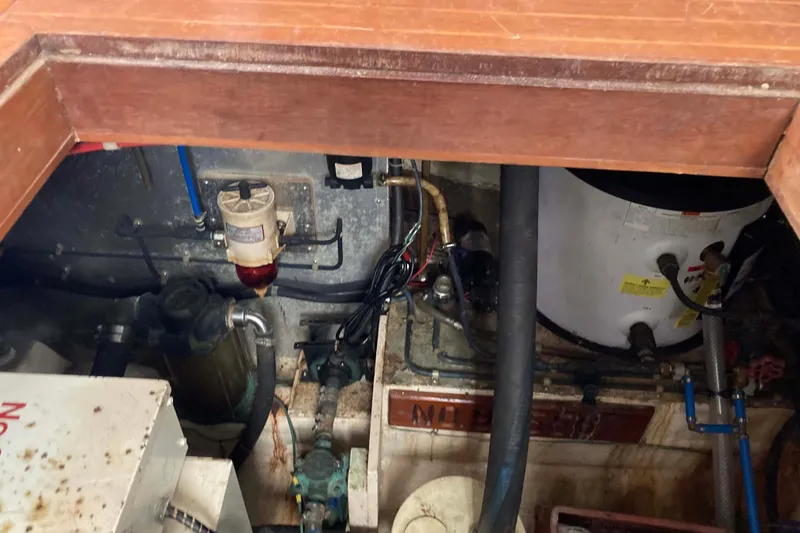 Slide: The Image of Engine room of a 1988 Albin 43 Trawler, showing mechanical components and wiring. - 45