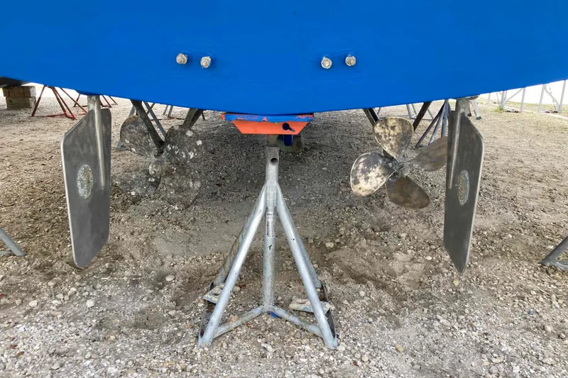 Slide: The Image of 1988 Albin 43 Trawler propellers and rudders on dry dock, supported by stands. - 47