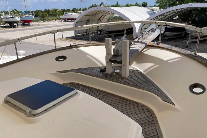 Slide: The Image of 1988 Albin 43 Trawler deck with anchor, docked in a boatyard. - 6