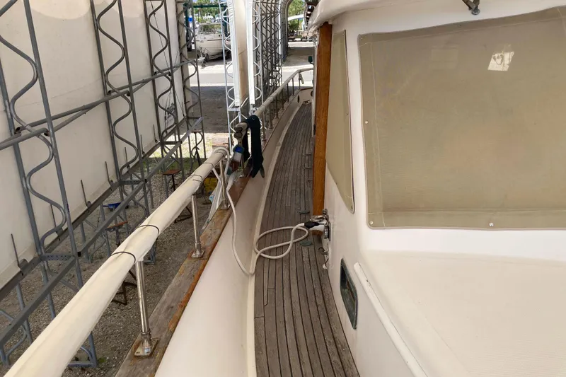 Slide: The Image of 1988 Albin 43 Trawler deck view with wooden railings and protective cover. - 8