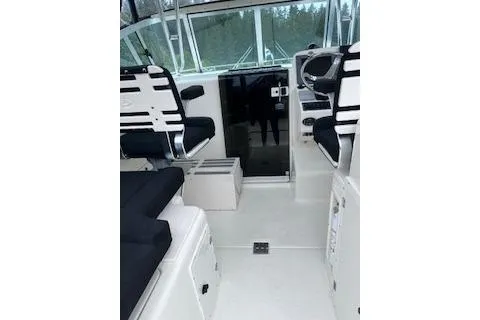 Slide: The Image of 2005 Pursuit 3070 Offshore boat interior with seating and helm controls. - 13