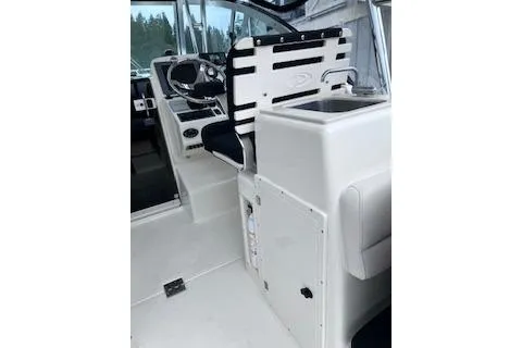 Slide: The Image of 2005 Pursuit 3070 Offshore boat interior with helm and seating area. - 14