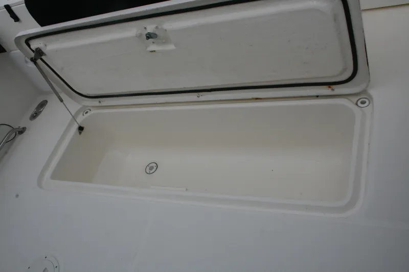 Slide: The Image of Open storage compartment on a 2005 Pursuit 3070 Offshore boat. - 17