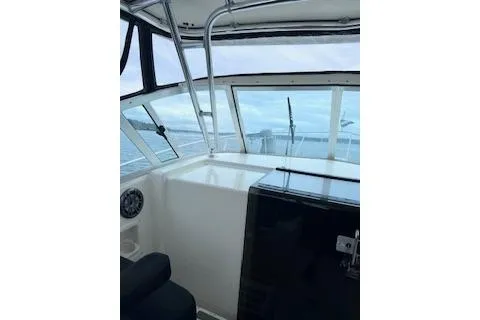 Slide: The Image of 2005 Pursuit 3070 Offshore boat interior with ocean view through windows. - 2