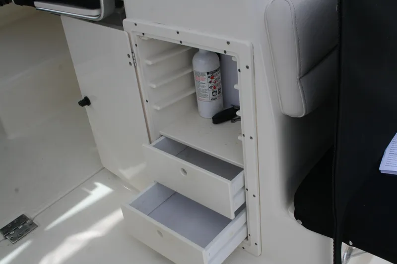 Slide: The Image of Storage compartment with drawers and fire extinguisher on 2005 Pursuit 3070 Offshore boat. - 22