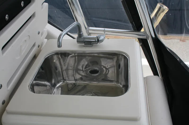 Slide: The Image of Stainless steel sink on 2005 Pursuit 3070 Offshore boat, featuring a sleek faucet design. - 23