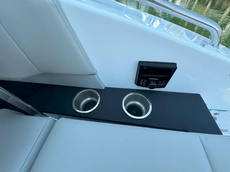 Slide: The Image of 2025 Cruisers Yachts 34 GLS Outboard interior with cup holders and control panel. - 19