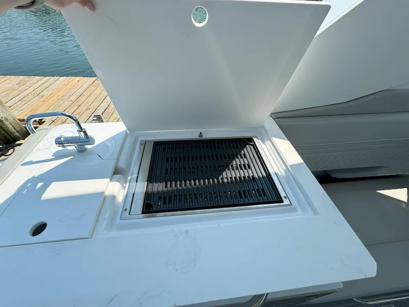 Slide: The Image of 2025 Cruisers Yachts 34 GLS Outboard grill and sink on deck. - 23