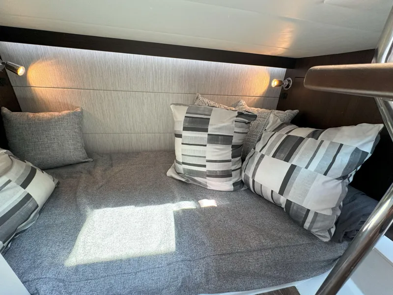 Slide: The Image of Cozy cabin interior of 2025 Cruisers Yachts 34 GLS Outboard with stylish pillows. - 49