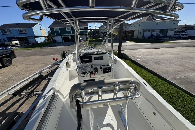 Slide: The Image of 2016 NauticStar 231 Coastal boat interior with steering console and rod holders. - 13