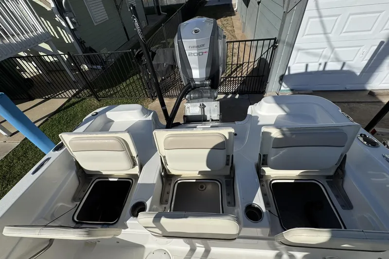 Slide: The Image of 2016 NauticStar 231 Coastal boat with Evinrude 200 HP engine, open storage compartments. - 15