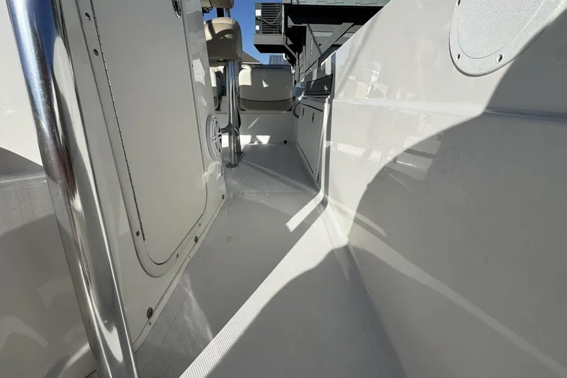 Slide: The Image of 2016 NauticStar 231 Coastal boat interior with sleek white deck and seating. - 18