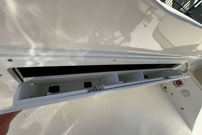 Slide: The Image of Open storage compartment on a 2016 NauticStar 231 Coastal boat. - 20