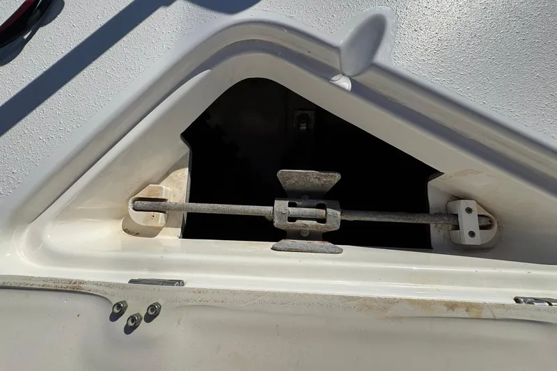 Slide: The Image of Open anchor locker on 2016 NauticStar 231 Coastal boat, showing metal latch mechanism. - 24