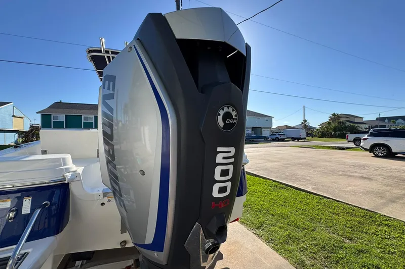 Slide: The Image of 2016 NauticStar 231 Coastal boat with Evinrude 200 HP outboard motor in a residential area. - 8