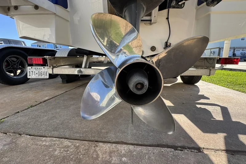 Slide: The Image of 2016 NauticStar 231 Coastal boat propeller on trailer, close-up view. - 9