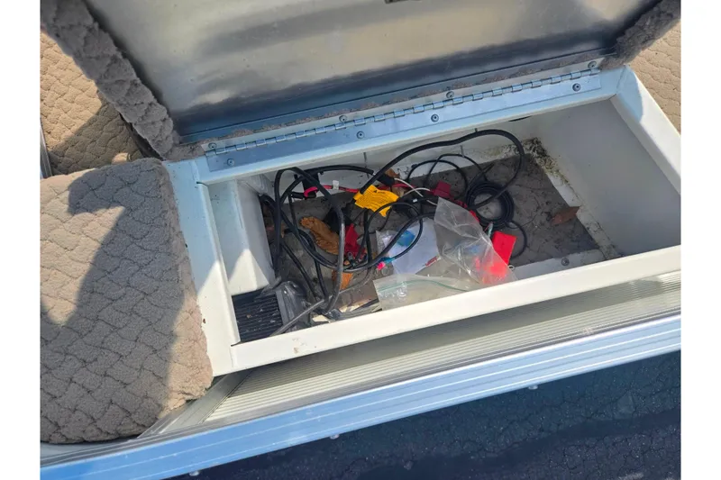 Slide: The Image of Storage compartment of a 2006 Suncruiser Trinidad 220 boat with cables and miscellaneous items. - 11