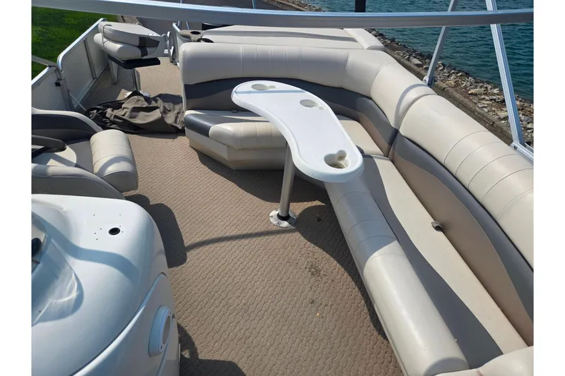 Slide: The Image of 2006 Suncruiser Trinidad 220 pontoon boat interior with beige seating and table. - 14