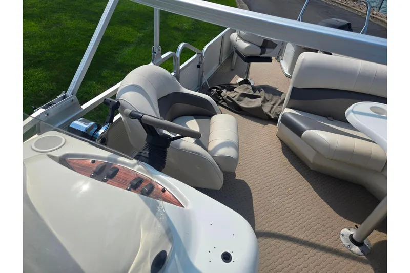 Slide: The Image of Interior of a 2006 Suncruiser Trinidad 220 pontoon boat with beige seating. - 15