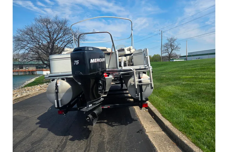 Slide: The Image of 2006 Suncruiser Trinidad 220 pontoon boat with Mercury 75 engine on a trailer. - 2
