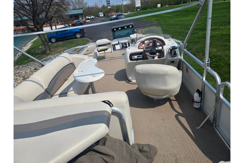 Slide: The Image of Interior of a 2006 Suncruiser Trinidad 220 pontoon boat with seating and steering console. - 21