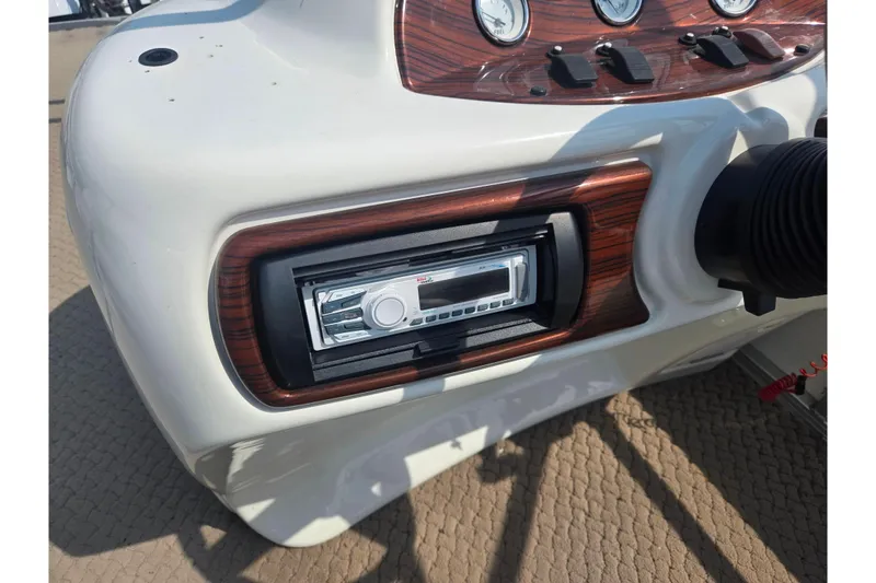 Slide: The Image of Control panel of a 2006 Suncruiser Trinidad 220 boat with stereo system. - 24