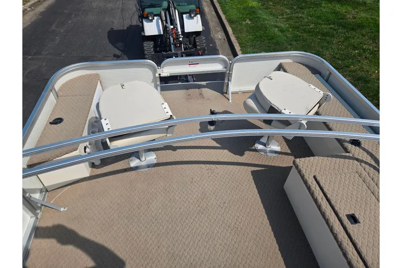 Slide: The Image of 2006 Suncruiser Trinidad 220 pontoon boat interior with seating and table setup. - 25