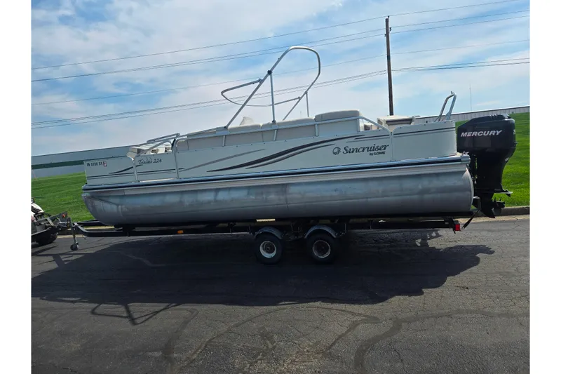 Slide: The Image of 2006 Suncruiser Trinidad 220 pontoon boat on trailer, featuring Mercury outboard motor. - 4