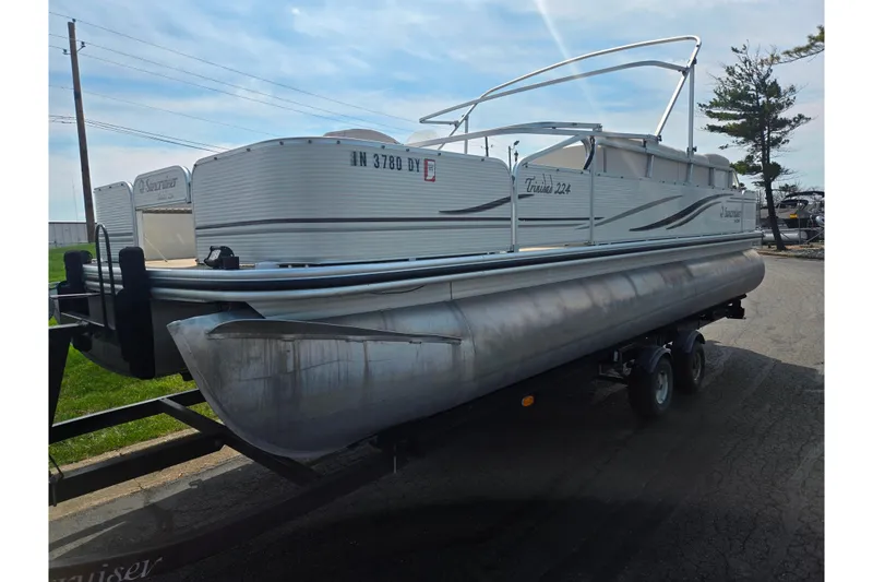 Slide: The Image of 2006 Suncruiser Trinidad 220 pontoon boat on trailer, parked outdoors. - 5