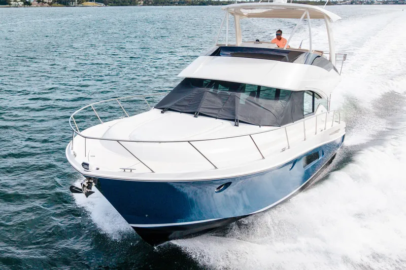 Slide: The Image of 2015 Tiara Yachts cruising on open water, showcasing sleek design and performance. - 10