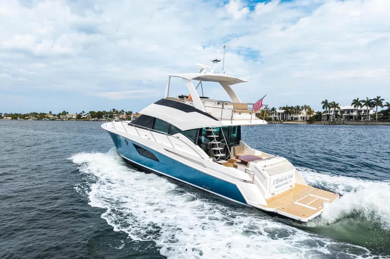 Slide: The Image of 2015 Tiara Yachts cruising on water, showcasing sleek design and luxury features. - 12