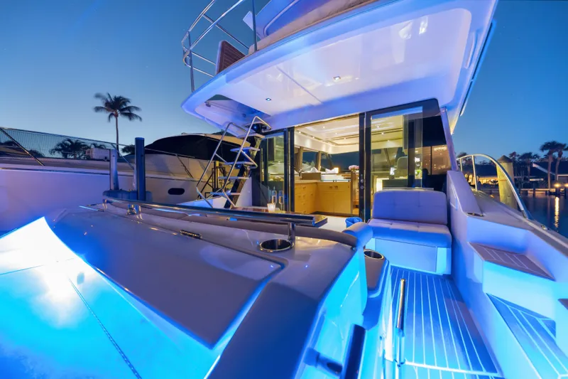 Slide: The Image of Luxurious 2015 Tiara Yachts with blue LED lighting at dusk, showcasing elegant design. - 14